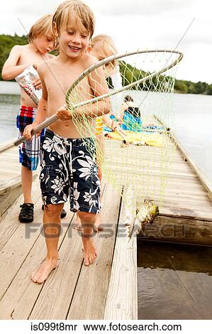 Boy with frog in a fishing net View Large Photo Image Stock Photography - Boy with frog in a fishing net. Fotosearch