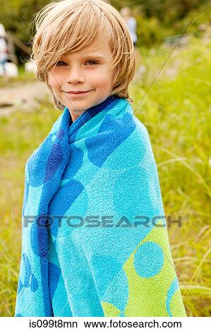 Boy wrapped in a towel outdoors View Large Photo Image Picture - Boy wrapped in a towel outdoors. Fotosearch