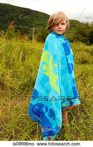 Boy wrapped in a towel outdoors View Large Photo Image Picture - Boy wrapped in a towel outdoors. Fotosearch