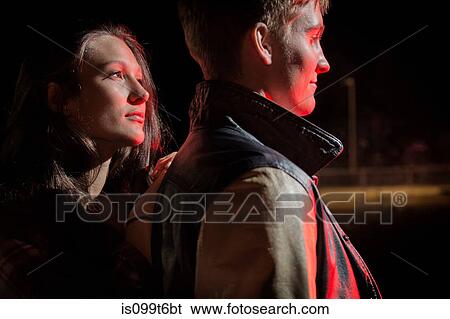 Close up of couple outdoors at night View Large Photo Image Stock Photograph - Close up of couple outdoors at night. Fotosearch