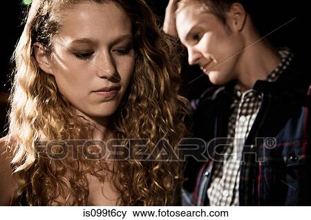 Stock Photo - Couple close up, girl looking down. Fotosearch
