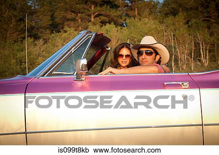 Couple in a convertible car View Large Photo Image Stock Image - Couple in a convertible car. Fotosearch