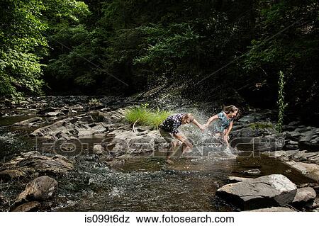 Couple playing in river View Large Photo Image Stock Photo - Couple playing in river. Fotosearch
