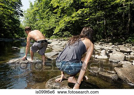 Stock Photograph - Couple playing in river. Fotosearch
