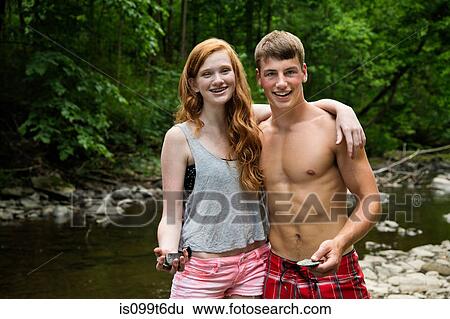 Couple standing by river, portrait View Large Photo Image Stock Photograph - Couple standing by river, portrait. Fotosearch