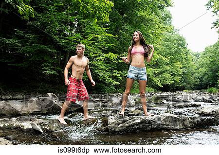 Stock Photography - Couple standing by river. Fotosearch