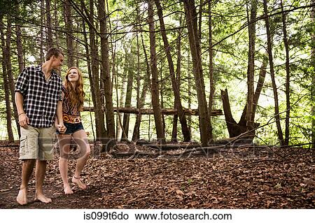 Picture - Couple walking through forest. Fotosearch