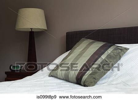 Cushion on a bed View Large Photo Image Stock Photo - Cushion on a bed. Fotosearch