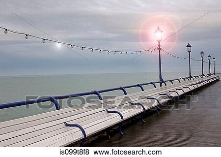 Empty benches on seaside pier, Eastbourne, East Sussex, UK View Large Photo Image Stock Photo - Empty benches on seaside pier, Eastbourne, East Sussex, UK. Fotosearch