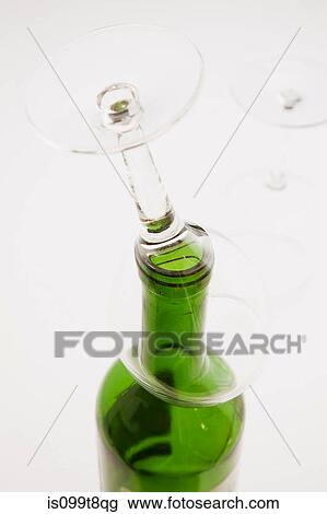 Empty wine glass on top of wine bottle View Large Photo Image Stock Image - Empty wine glass on top of wine bottle. Fotosearch