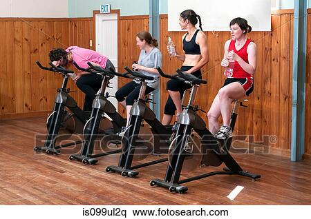 Stock Photography - Exhausted woman in spinning class. Fotosearch