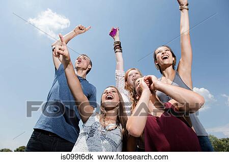 Five friends cheering, low angle View Large Photo Image Stock Image - Five friends cheering, low angle. Fotosearch