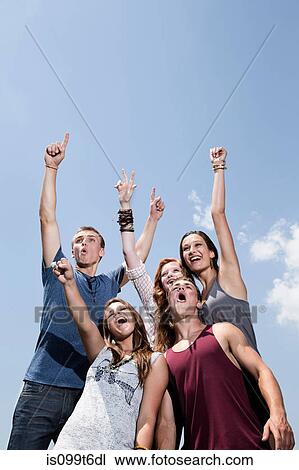 Five friends cheering, low angle View Large Photo Image Stock Image - Five friends cheering, low angle. Fotosearch