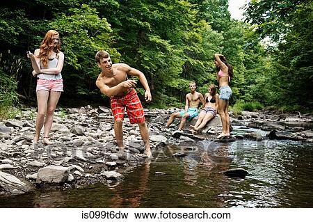 Five friends playing by river View Large Photo Image Stock Photo - Five friends playing by river. Fotosearch