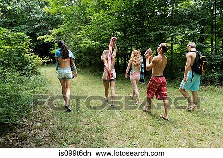 Five friends walking on grass, rear view View Large Photo Image Picture - Five friends walking on grass, rear view. Fotosearch