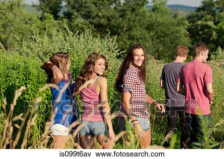 Five friends walking through field View Large Photo Image Stock Photo - Five friends walking through field. Fotosearch