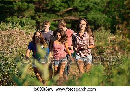 Stock Photo - Five friends walking through field. Fotosearch
