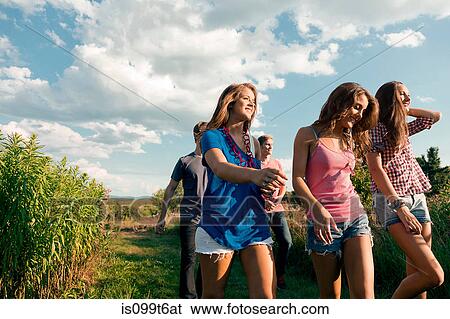Five friends walking through field View Large Photo Image Stock Photograph - Five friends walking through field. Fotosearch