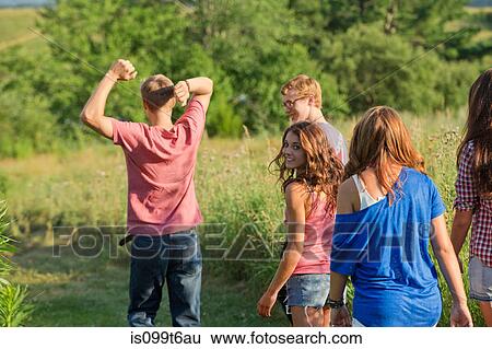 Five friends walking through field View Large Photo Image Stock Photograph - Five friends walking through field. Fotosearch