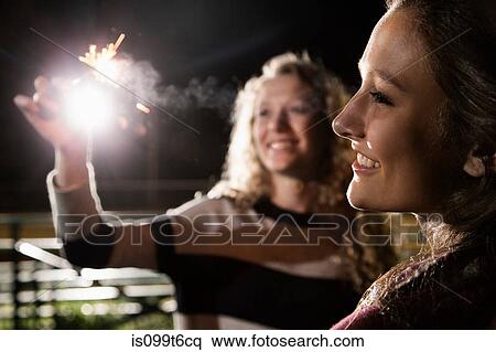 Friends holding sparkler View Large Photo Image Stock Photography - Friends holding sparkler. Fotosearch