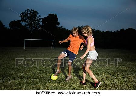 Friends playing soccer at night View Large Photo Image Stock Image - Friends playing soccer at night. Fotosearch