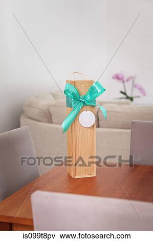 Gift box with ribbon on a table View Large Photo Image Stock Photo - Gift box with ribbon on a table. Fotosearch