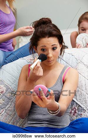 Girl applying makeup in bedroom View Large Photo Image Stock Photo - Girl applying makeup in bedroom. Fotosearch