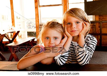 Stock Photo - Girl close to boy at picnic table. Fotosearch