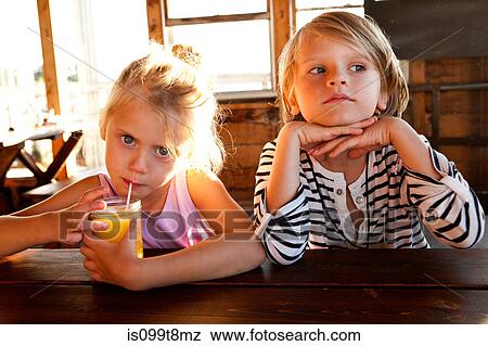 Girl drinking juice and boy looking thoughtful View Large Photo Image Stock Photo - Girl drinking juice and boy looking thoughtful. Fotosearch