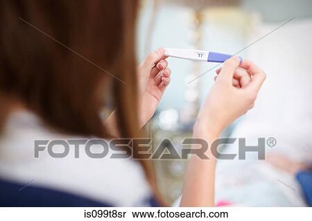 Girl holding a pregnancy test View Large Photo Image Stock Photography - Girl holding a pregnancy test. Fotosearch