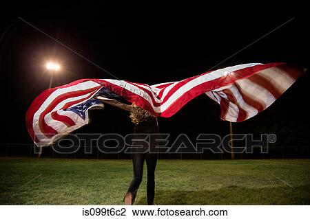 Girl holding american flag at night View Large Photo Image Stock Image - Girl holding american flag at night. Fotosearch