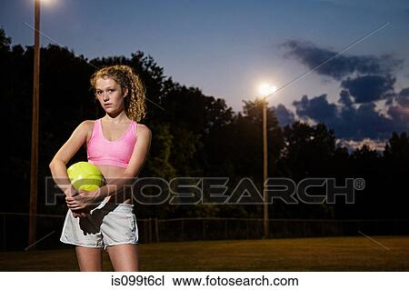 Girl holding soccer ball at night View Large Photo Image Stock Image - Girl holding soccer ball at night. Fotosearch
