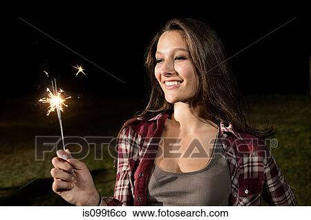 Picture - Girl holding sparkler. Fotosearch