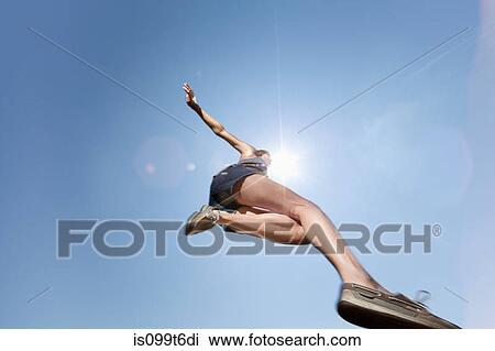 Girl jumping against blue sky, low angle View Large Photo Image Stock Image - Girl jumping against blue sky, low angle. Fotosearch