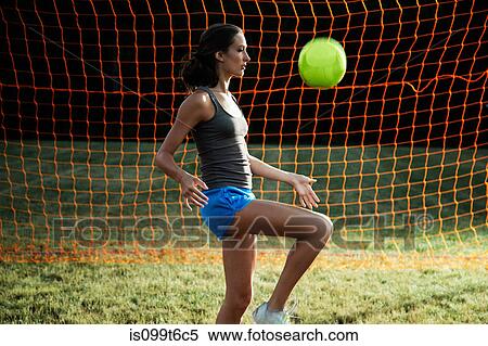 Stock Photography - Girl playing keepy uppy with soccer ball. Fotosearch