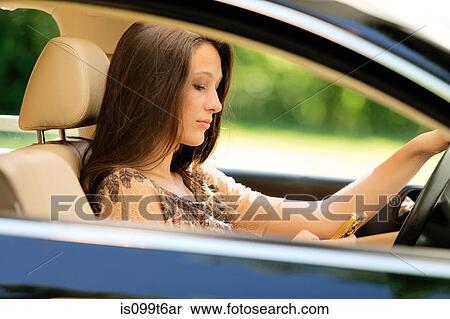 Girl sitting in drivers seat of car using cell phone View Large Photo Image Stock Photography - Girl sitting in drivers seat of car using cell phone. Fotosearch