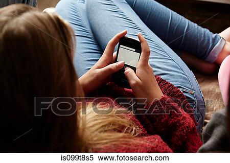 Girl using smartphone View Large Photo Image Stock Photography - Girl using smartphone. Fotosearch