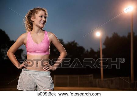 Girl wearing pink crop top with hands on hips View Large Photo Image Stock Image - Girl wearing pink crop top with hands on hips. Fotosearch