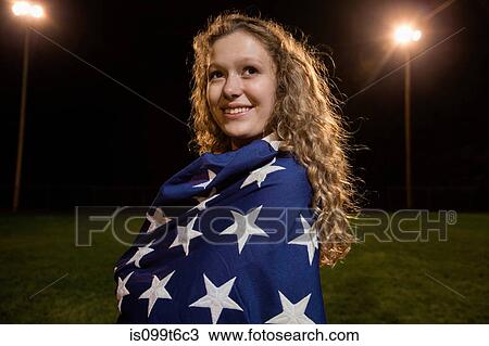 Girl wrapped in american flag at night View Large Photo Image Stock Image - Girl wrapped in american flag at night. Fotosearch