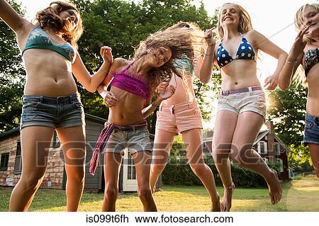 Girls dancing in garden View Large Photo Image Stock Image - Girls dancing in garden. Fotosearch