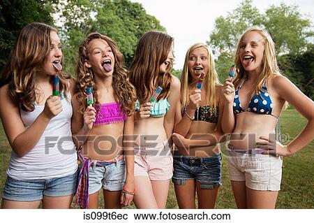 Stock Image - Girls eating ice lollies. Fotosearch