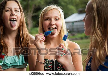 Stock Image - Girls eating ice lollies. Fotosearch
