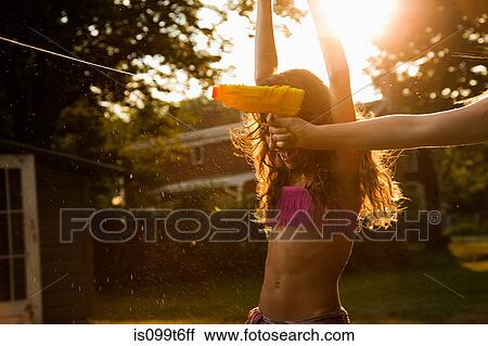 Girls having water fight with water pistols View Large Photo Image Stock Image - Girls having water fight with water pistols. Fotosearch
