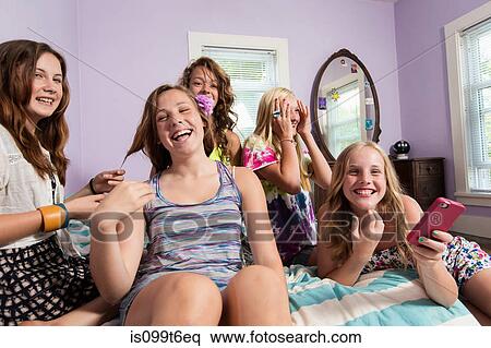 Girls using smartphone in bedroom View Large Photo Image Stock Photography - Girls using smartphone in bedroom. Fotosearch