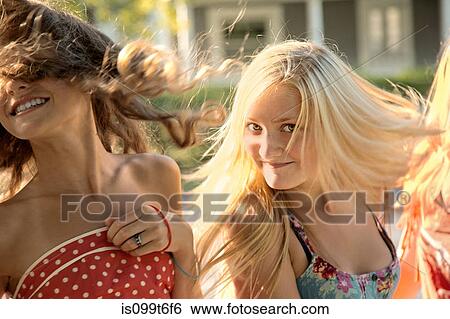 Stock Photograph - Girls with long hair in sunlight. Fotosearch