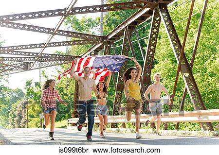 Group of friends running on bridge holding american flag View Large Photo Image Stock Photography - Group of friends running on bridge holding american flag. Fotosearch