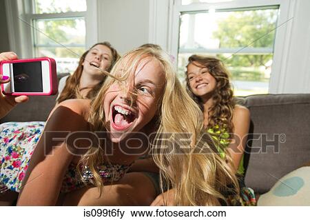 Group of girls being photographed with camera phone View Large Photo Image Stock Photo - Group of girls being photographed with camera phone. Fotosearch