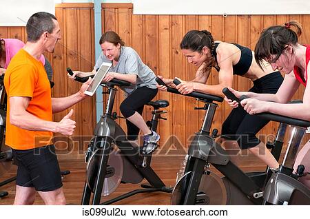 Instructor with digital tablet in spinning glass View Large Photo Image Stock Photograph - Instructor with digital tablet in spinning glass. Fotosearch