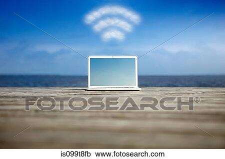 Laptop with wifi symbol at the coast View Large Photo Image Stock Image - Laptop with wifi symbol at the coast. Fotosearch