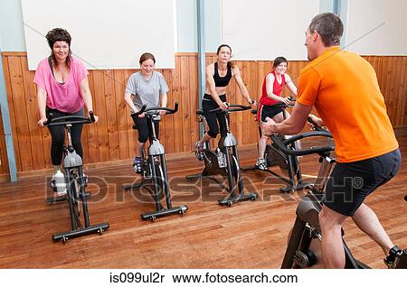 Male instructor and female spinning class View Large Photo Image Stock Photography - Male instructor and female spinning class. Fotosearch